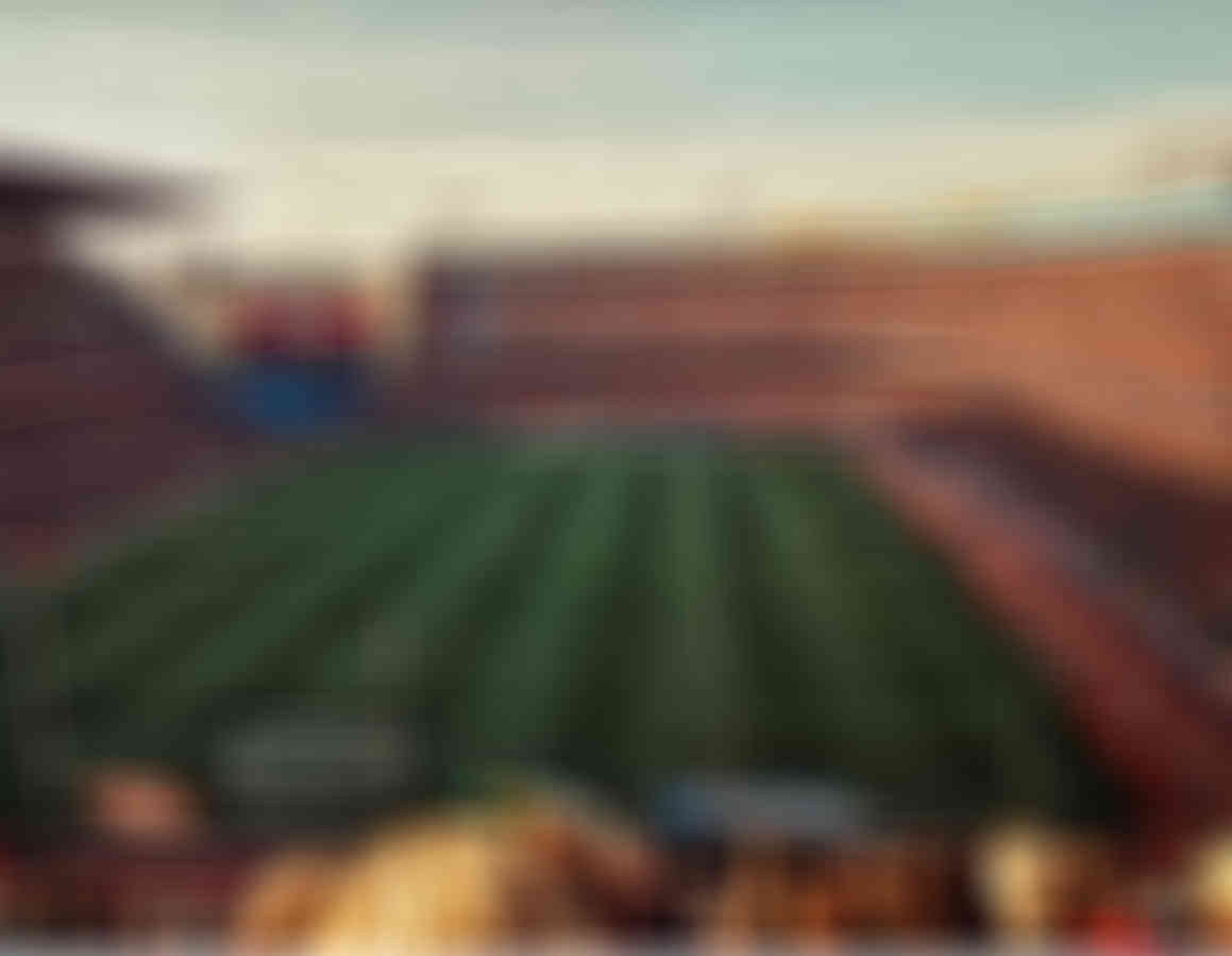 Blurred image of a sports stadium and crowd