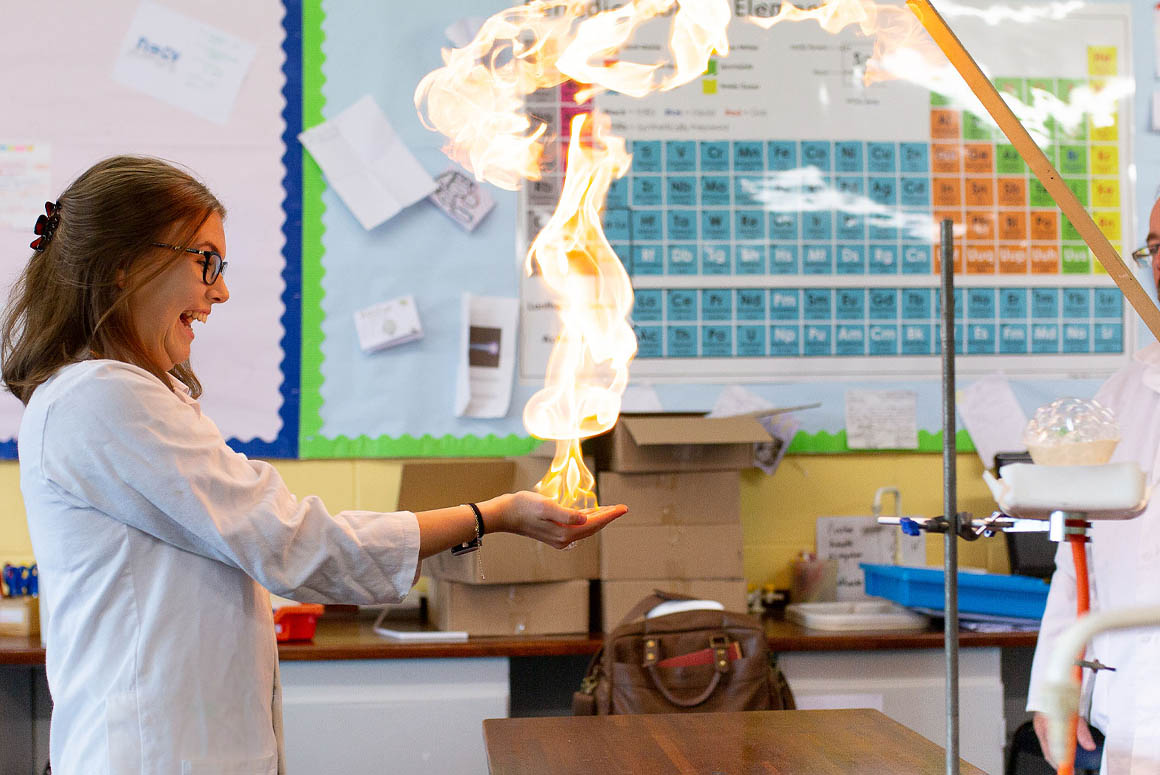 Student holding fireball in hands