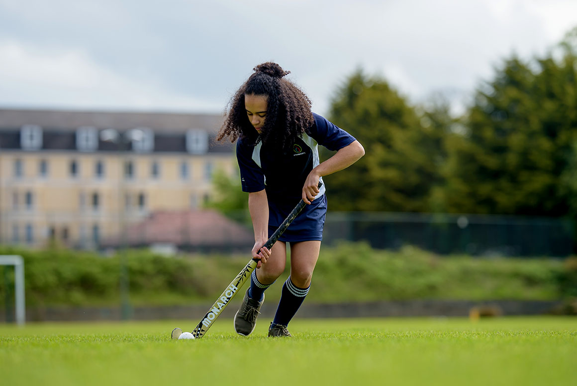 d'Overbroeck's school female student playing hockey outside