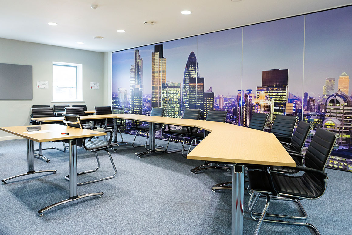 Meeting room with London skyline poster at King Edward's Witley