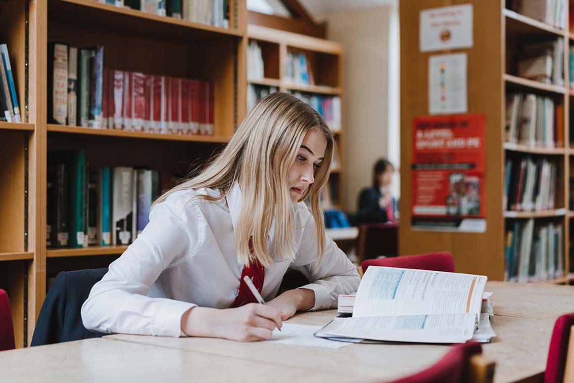Stamford High School student studying in a library