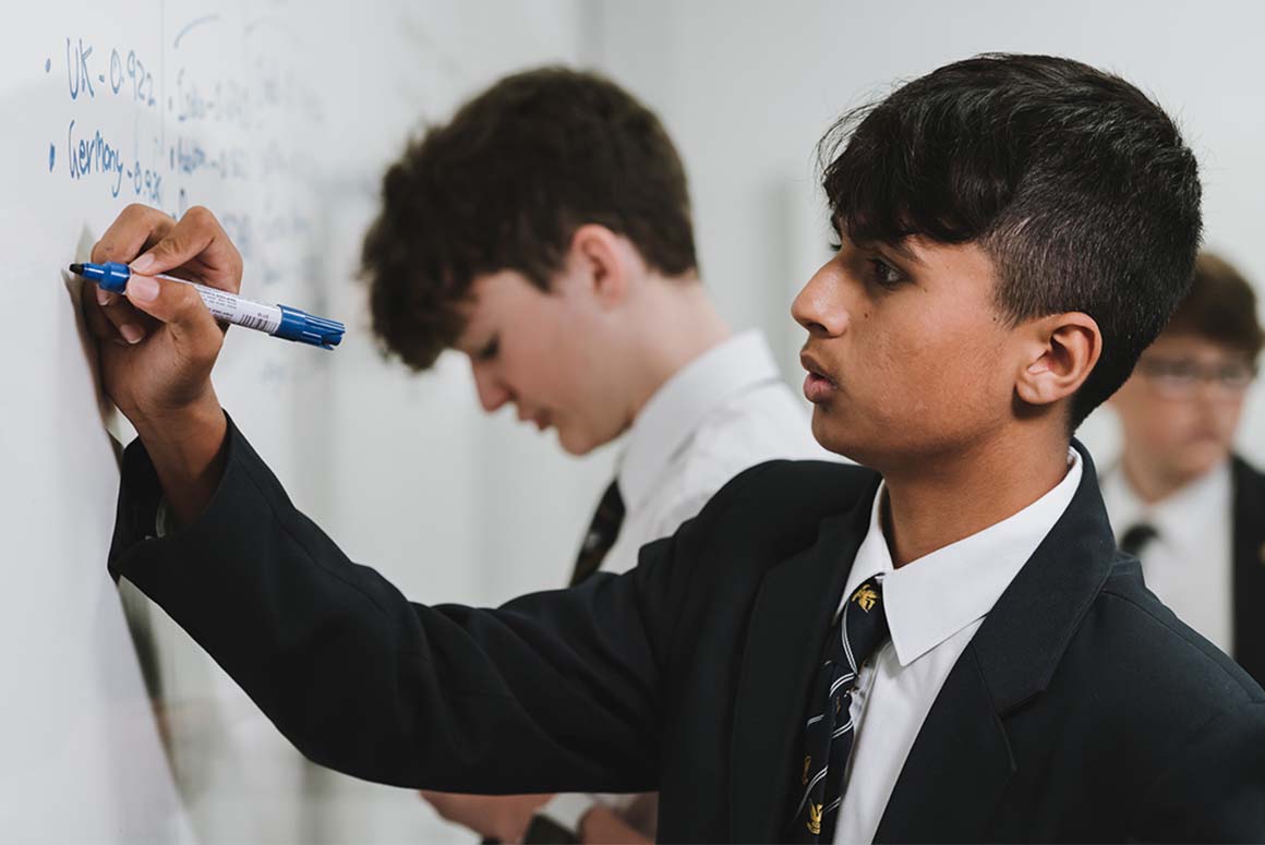 Stamford school students writing on whiteboard