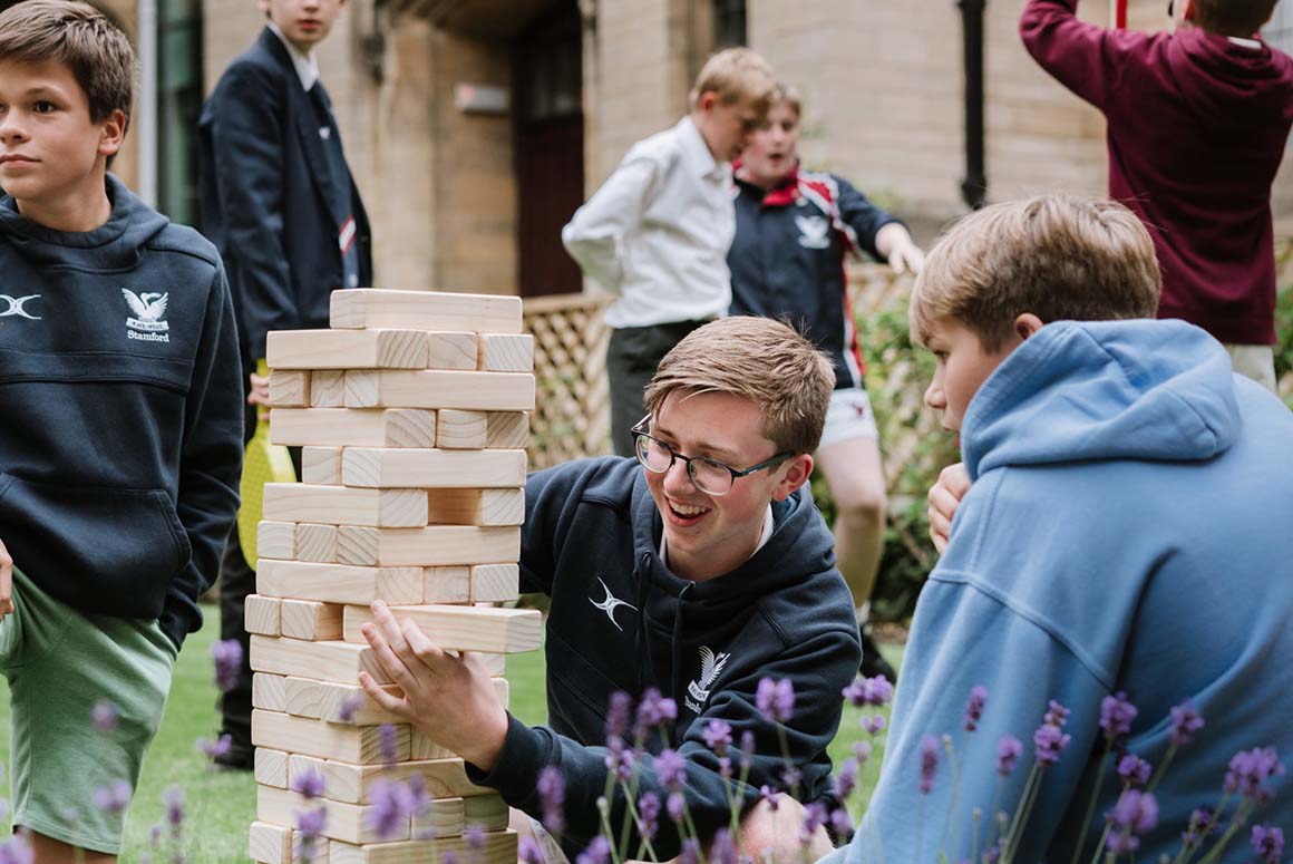 Stamford school students playing jenga outside