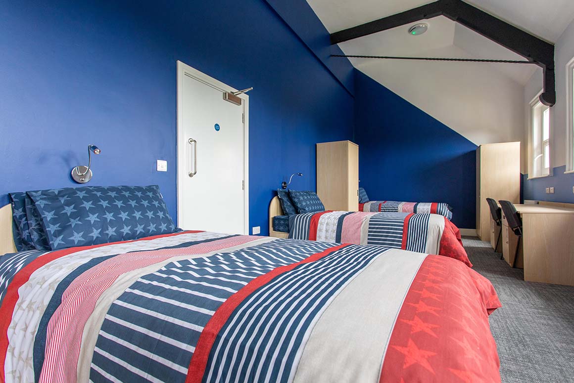 Tettenhall College dormitory room with three beds